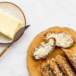Buttered bread on a plate.